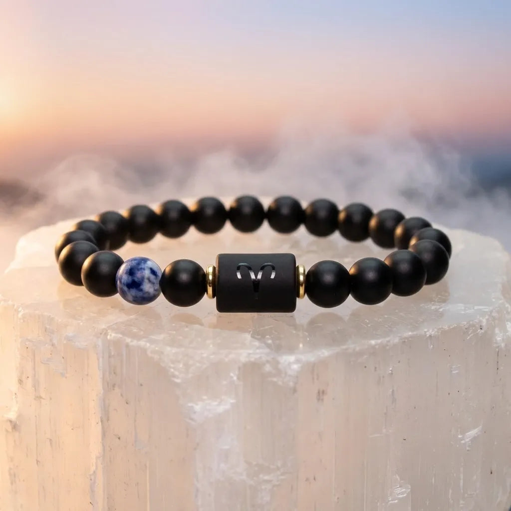 Aries zodiac bracelet displayed on crystal stone with black beads, blue gem accent, and calming luxury energy vibe