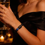 Aries zodiac bracelet worn with an elegant black dress, blue stone accent, and luxe evening statement style appeal