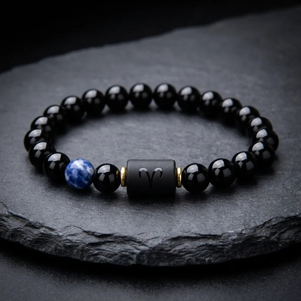 Aries zodiac bracelet on dark slate with glossy black beads, blue gemstone detail, and premium gift appeal today