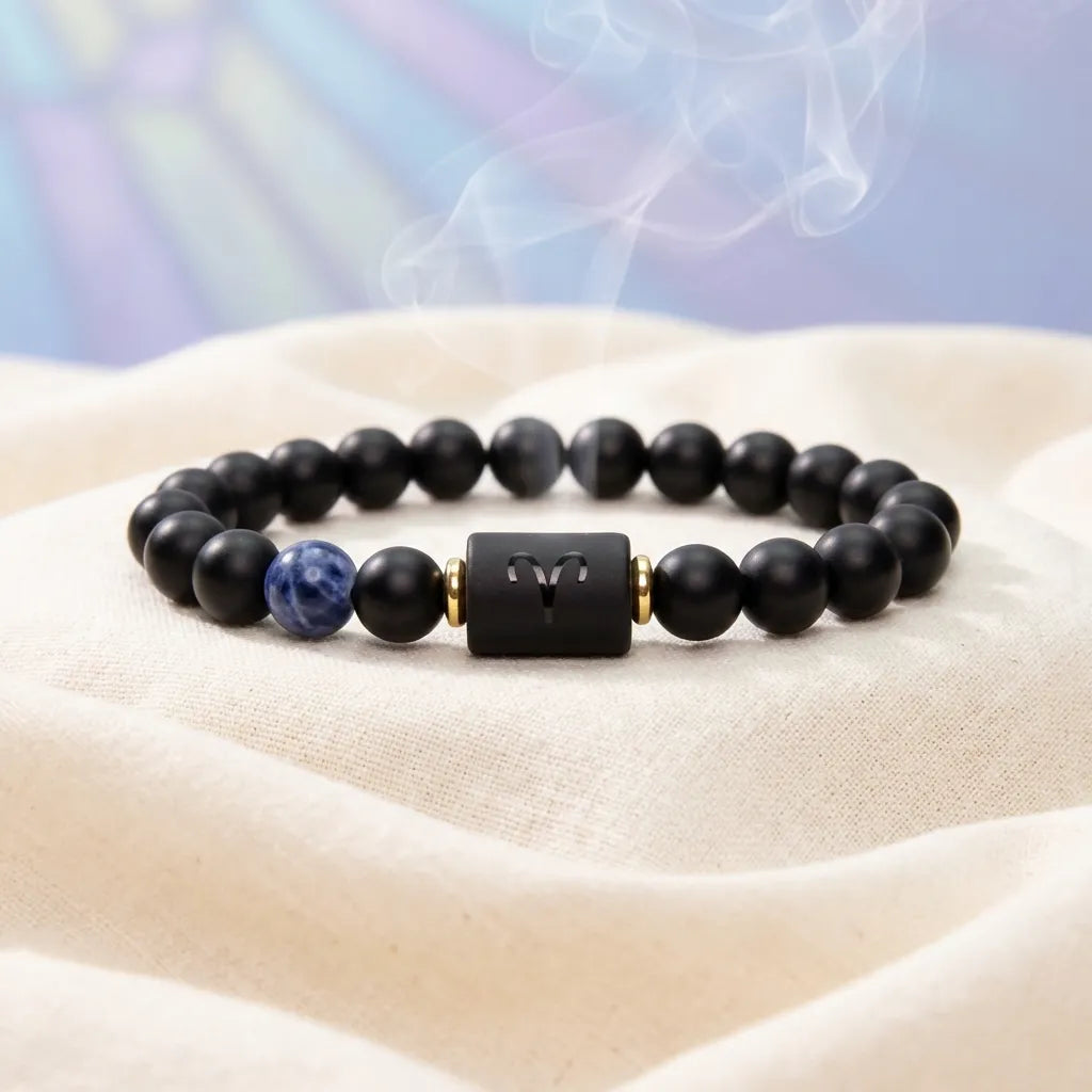 Aries zodiac bracelet on soft white fabric with black beads, blue stone accent, and calm healing style appeal now