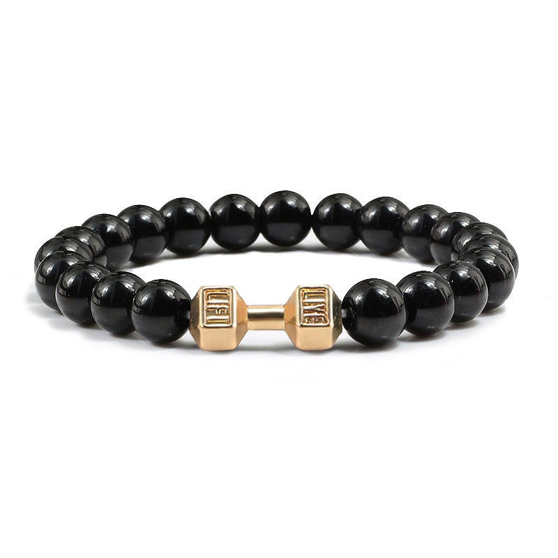 Barbell beaded bracelet in black with gold-color connector, showing 8 mm round beads, a dumbbell-shaped connector, and a circular unisex strand on a plain white jewelry background.