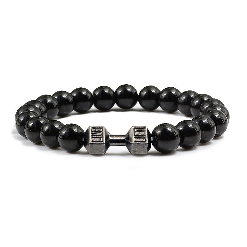 Barbell beaded bracelet in black with gun-black connector, showing 8 mm round beads, a dumbbell-shaped connector, and a circular unisex strand against a clean white studio setting.