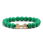 Barbell beaded bracelet in dark green with gold-color connector, showing 8 mm round beads, a dumbbell-shaped connector, and a circular unisex strand for an easy product comparison.