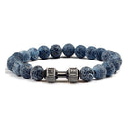 Barbell beaded bracelet in weathered dark blue with gun-black connector, showing 8 mm round beads, a dumbbell-shaped connector, and a circular unisex strand in a clean studio view.