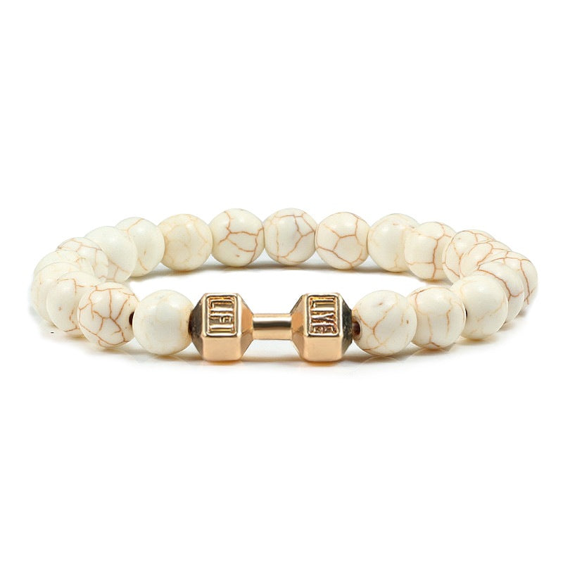 Barbell beaded bracelet in white porcelain with gold-color connector, showing 8 mm round beads, a dumbbell-shaped connector, and a circular unisex strand on a clean white backdrop.