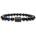 Libra zodiac bracelet with glossy black beads, blue accent stone, and engraved center bead on agate plate with smoke.