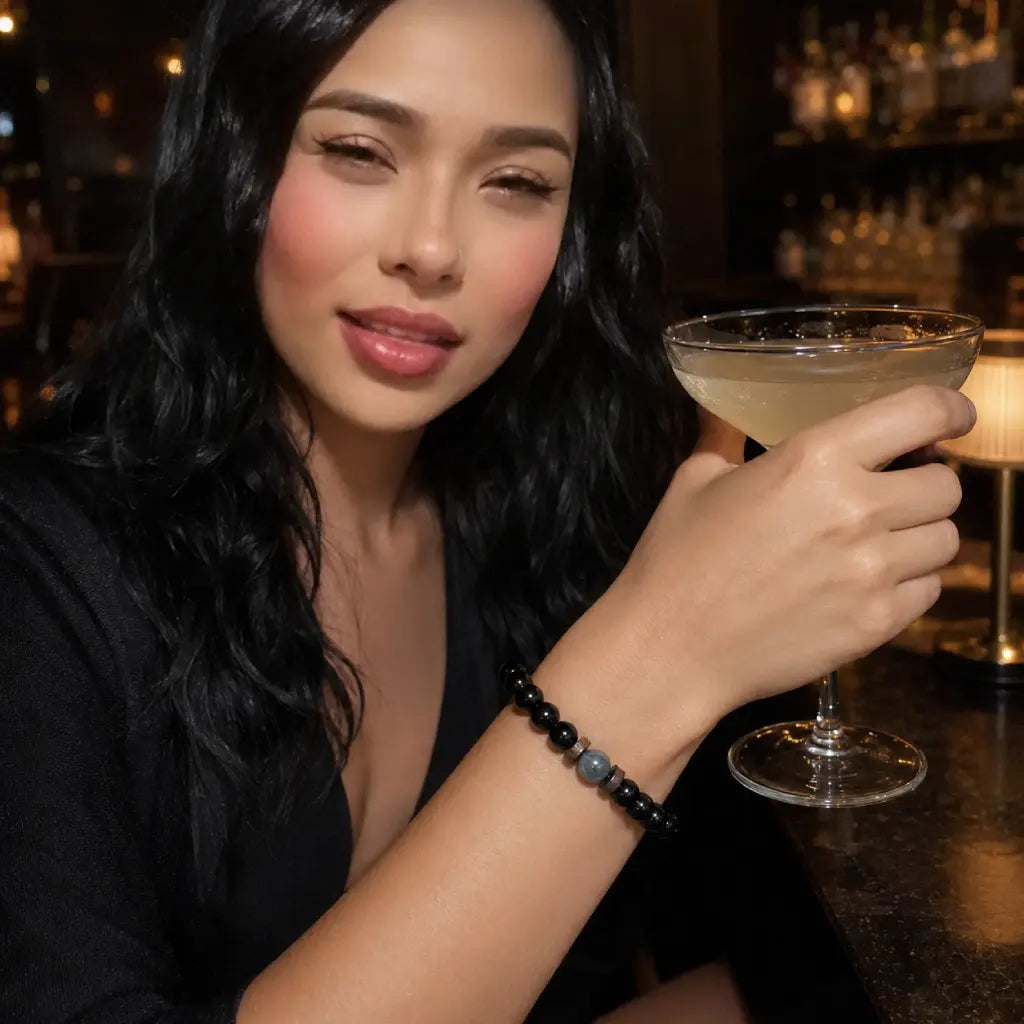 Black Obsidian labradorite gemstone bracelet paired with evening attire and cocktail highlighting polished crystal jewelry for luxury appeal.