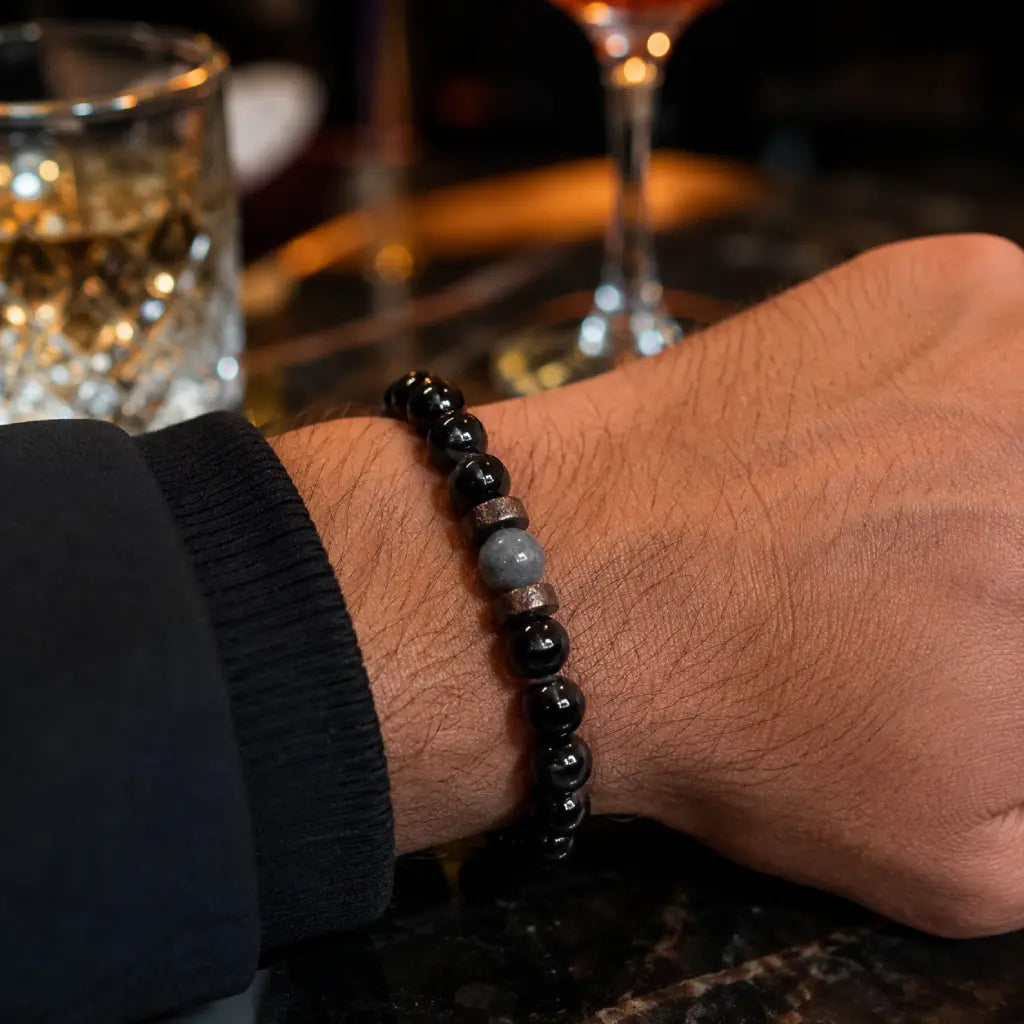 Black Obsidian labradorite gemstone bracelet close-up on wrist displaying polished crystal beads and natural wood accents for stylish everyday wear.