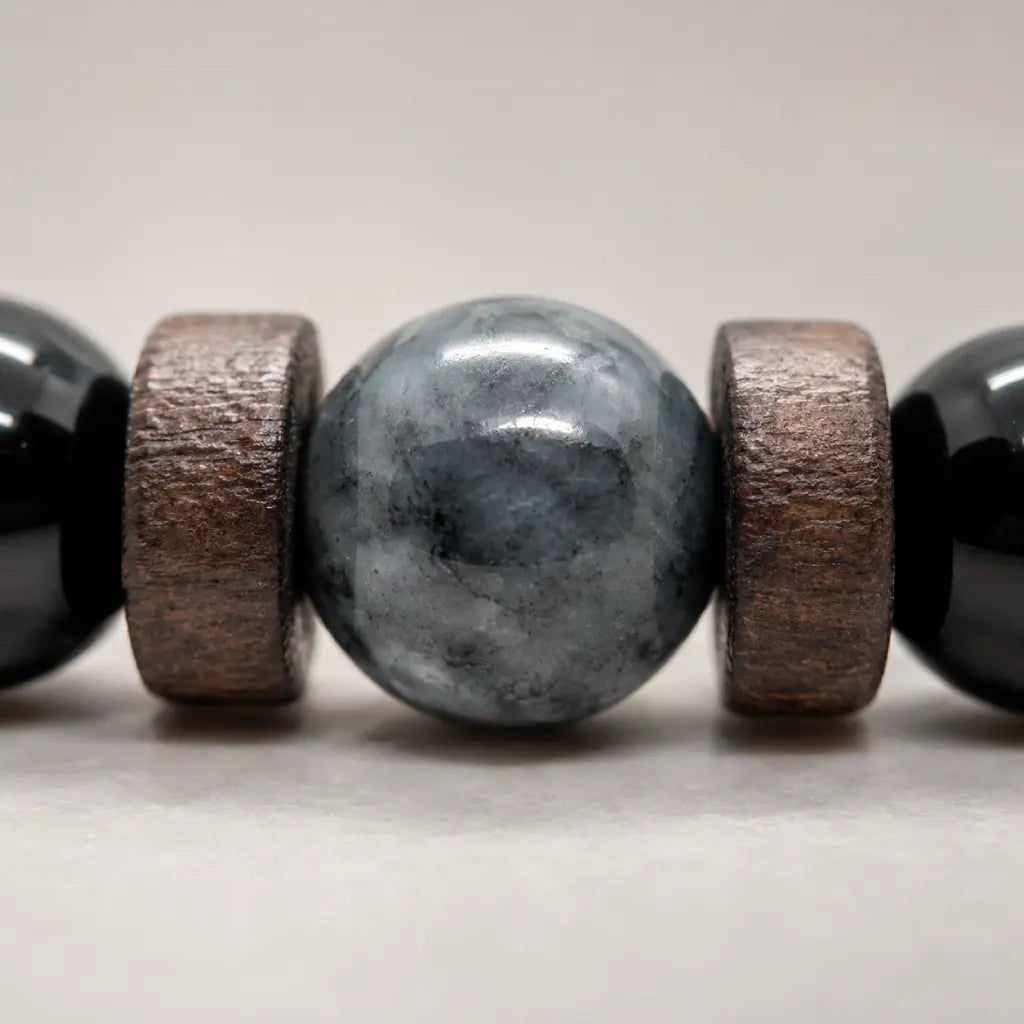 Black Obsidian labradorite bracelet macro showing the natural labradorite centerpiece with wood spacers and polished gemstone craftsmanship.