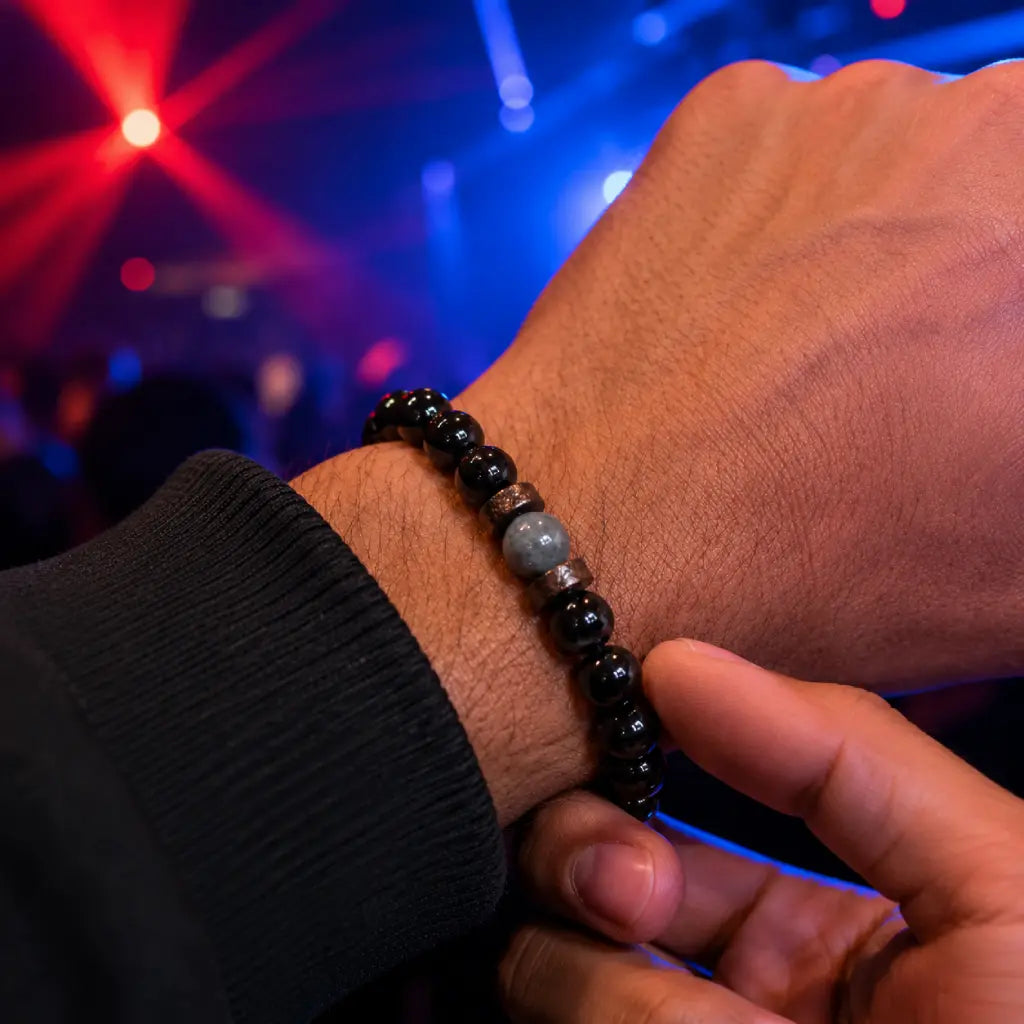 Black Obsidian labradorite bracelet worn on wrist in nightlife setting showcasing polished gemstone beads for fashionable everyday confidence.