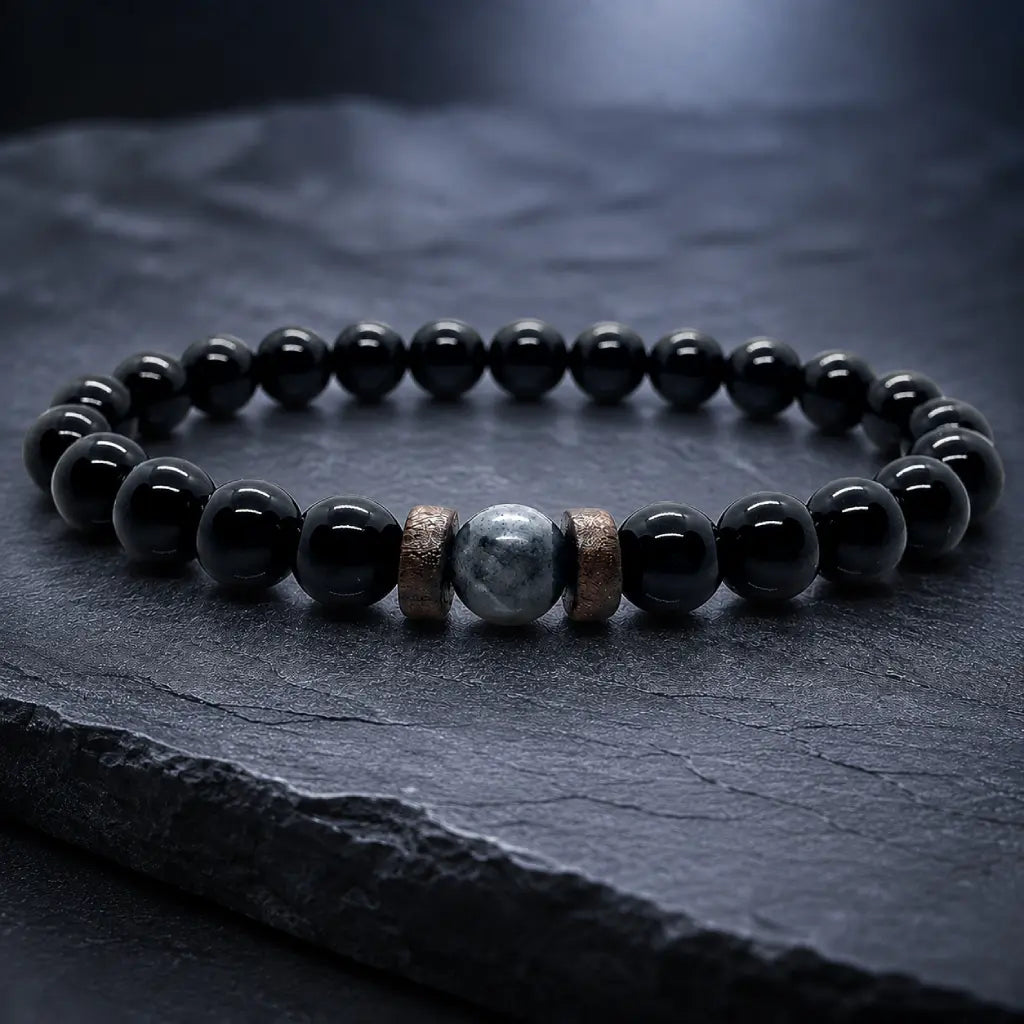 Black Obsidian labradorite gemstone bracelet displayed on a dark slate surface featuring polished natural crystal beads for premium everyday style.