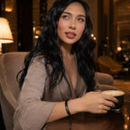 Black Obsidian labradorite bracelet worn by a woman enjoying coffee featuring polished gemstone beads for elegant everyday fashion.