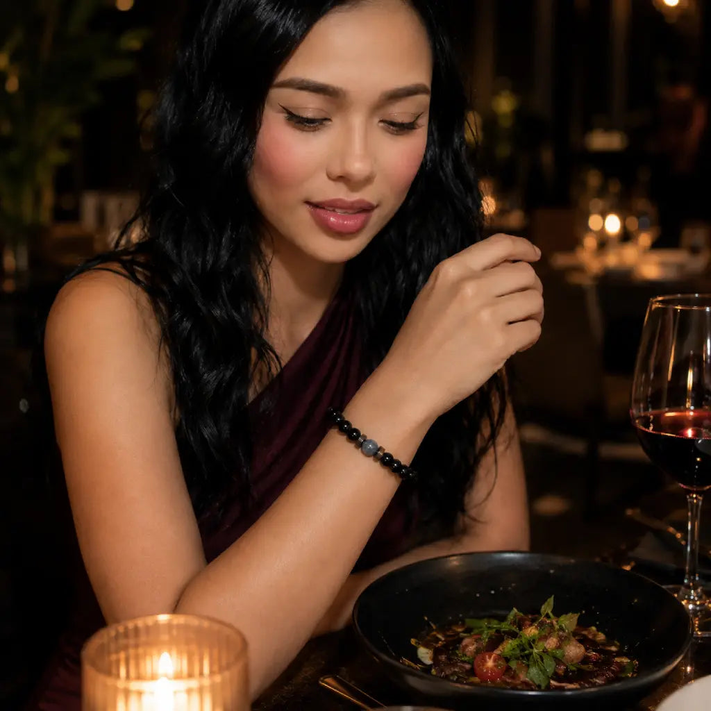 Black Obsidian labradorite bracelet worn by a woman at dinner featuring polished gemstone beads for elegant fashion and timeless accessories.