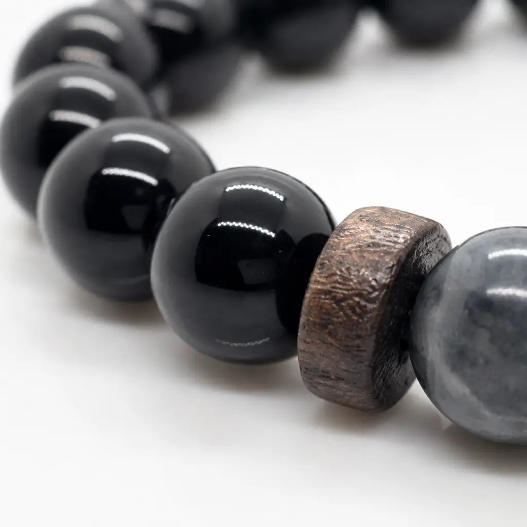 Black Obsidian labradorite bracelet close-up featuring glossy obsidian beads and natural wood spacers for premium handcrafted jewelry.