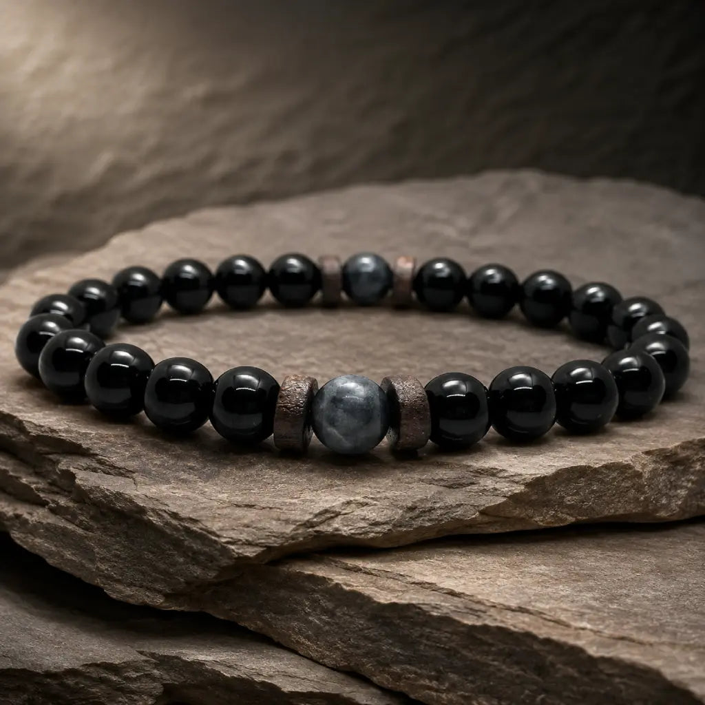Black Obsidian labradorite natural stone bracelet showcased on layered slate rock with polished crystal beads for timeless modern style.