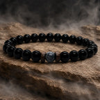 Black Obsidian labradorite beaded bracelet displayed on textured stone with soft mist emphasizing polished natural gemstone craftsmanship.
