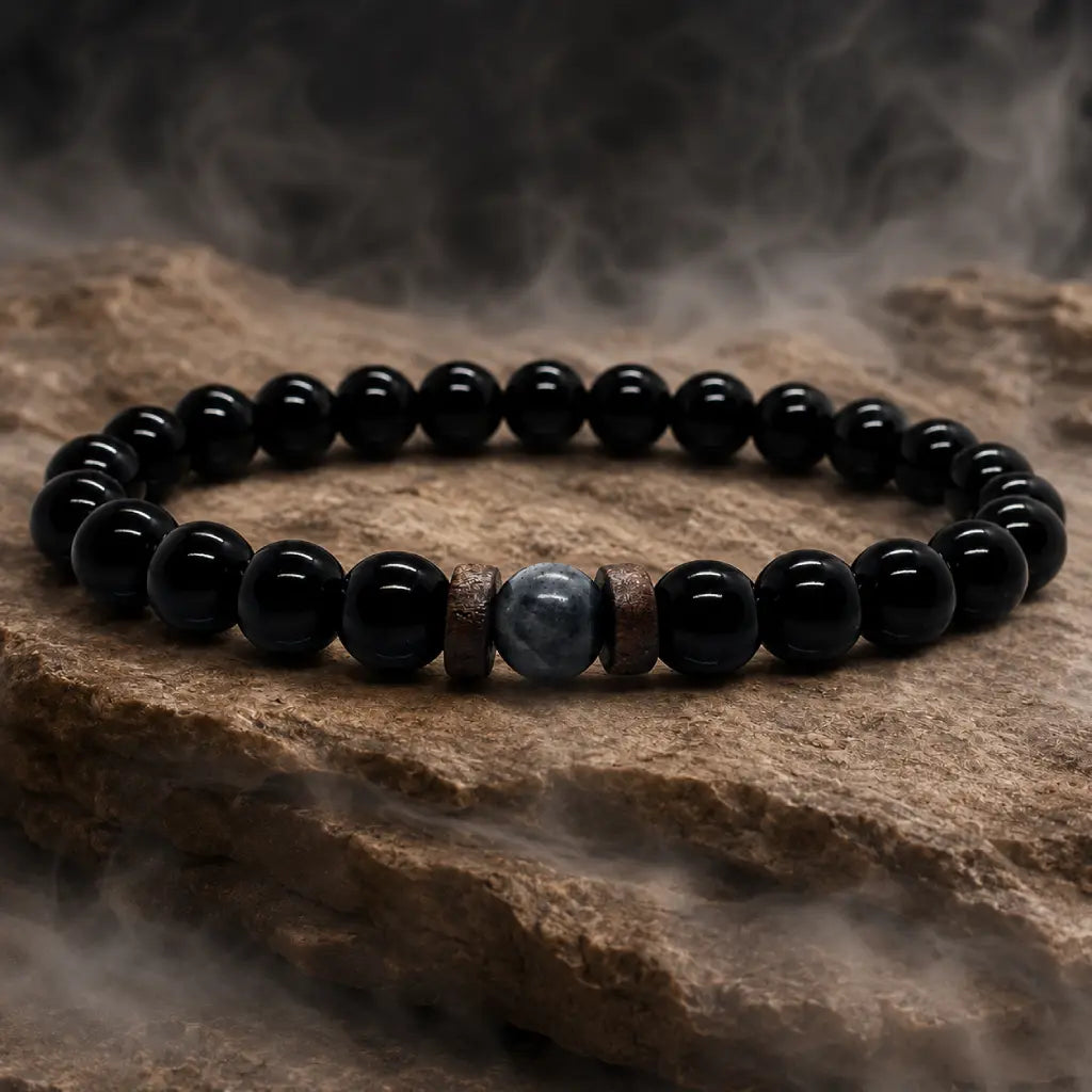 Black Obsidian labradorite beaded bracelet displayed on textured stone with soft mist emphasizing polished natural gemstone craftsmanship.