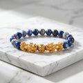Blue tiger eye bracelet with blue gray beads, gold Pixiu dragon charms, and marble slab for premium wealth style
