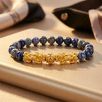 Blue tiger eye bracelet with gold Pixiu dragons, blue gray stone beads, and satin styling for luxury gift appea