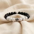 Black and white beaded bracelet on beige fabric