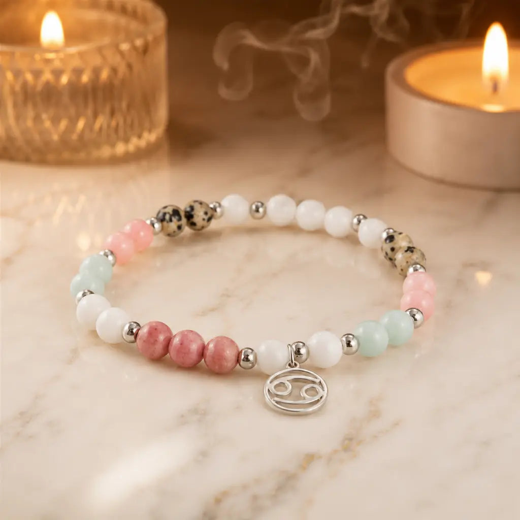 Cancer bracelet styled beside candles highlighting gemstone energy spiritual jewelry and zodiac symbolism