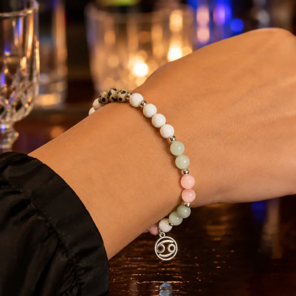 Cancer bracelet displayed on wrist at cocktail venue combining zodiac jewelry elegance with gemstone beauty