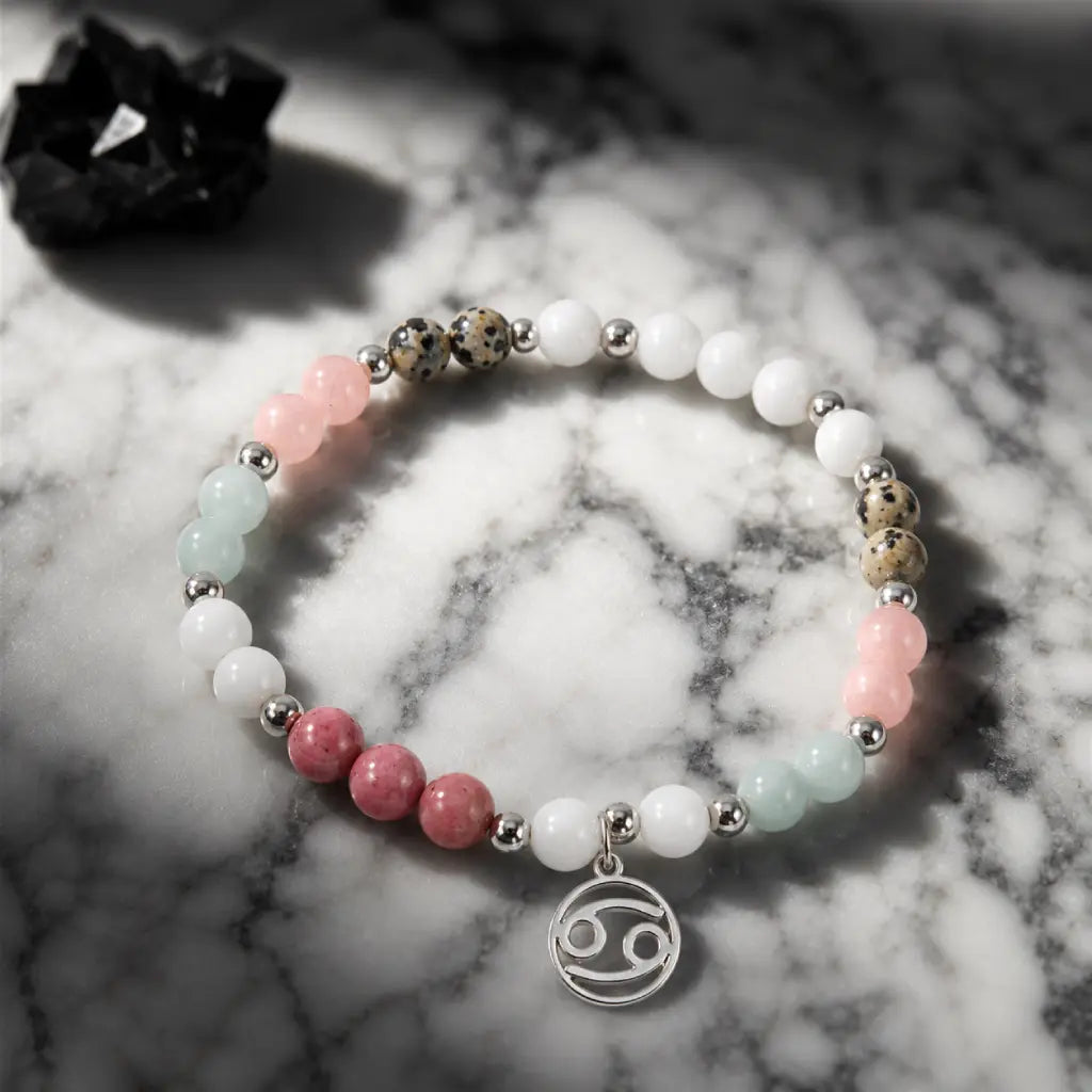 Cancer bracelet photographed on marble surface with natural gemstones silver details and zodiac inspired design