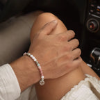 Cancer bracelet styled on wrist with natural gemstone beads and silver zodiac charm for everyday astrology fashion