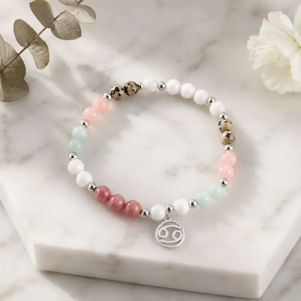 Cancer bracelet arranged on marble display with soft gemstone colors and silver zodiac charm for modern elegance