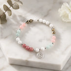 Cancer bracelet arranged on marble display with soft gemstone colors and silver zodiac charm for modern elegance