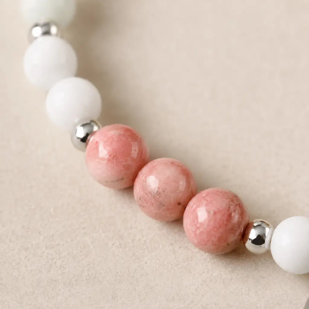 Cancer bracelet detailed view highlighting rhodonite beads white stones and artisan zodiac bracelet craftsmanship