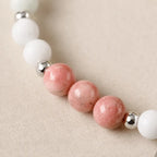 Cancer bracelet detailed view highlighting rhodonite beads white stones and artisan zodiac bracelet craftsmanship
