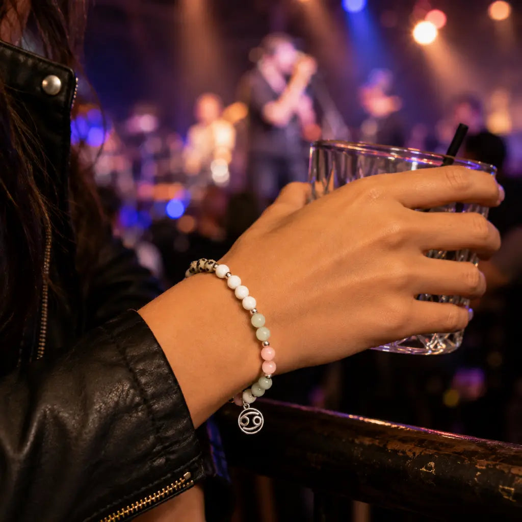 Cancer bracelet worn against city skyline featuring elegant gemstone beads and zodiac charm for modern style