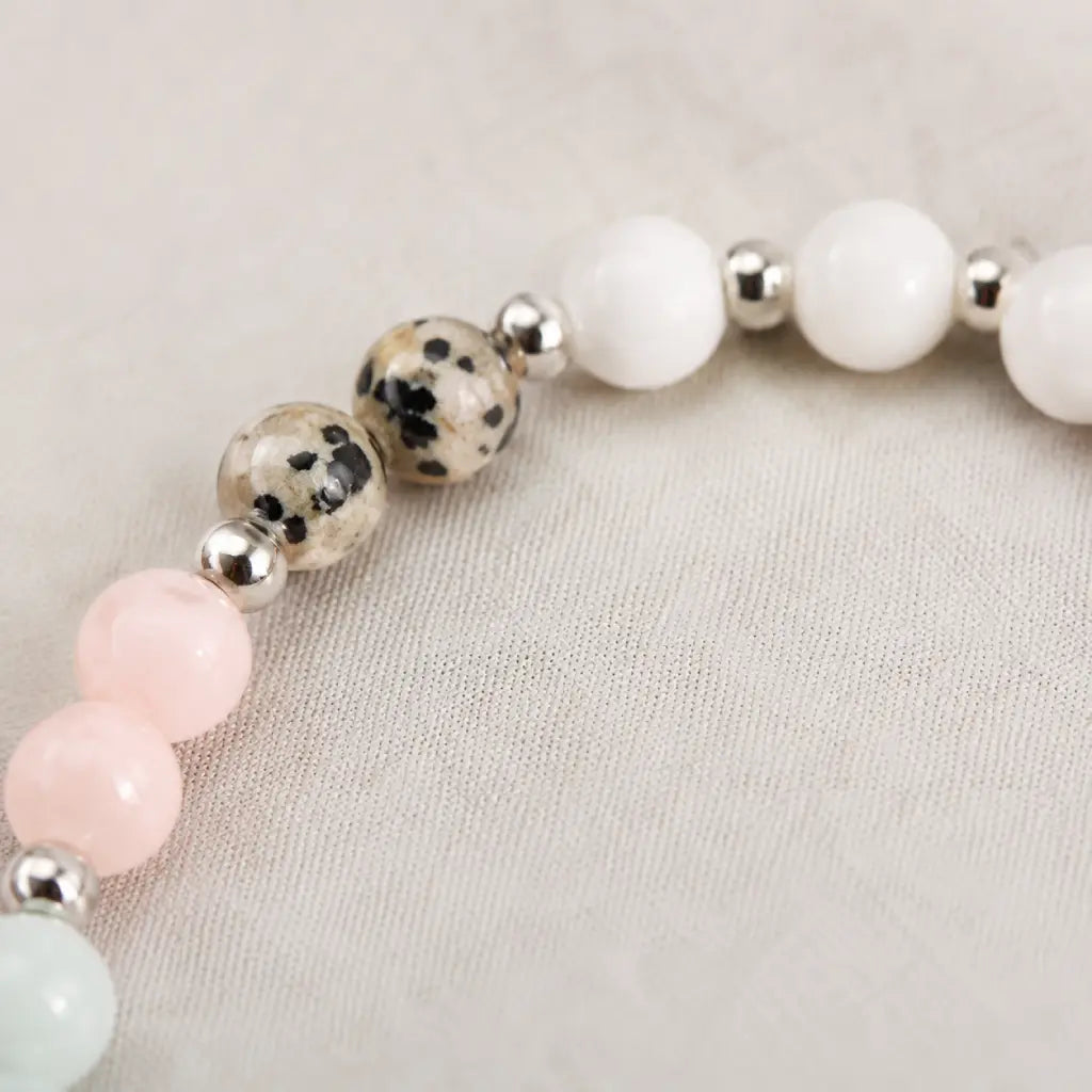 Cancer bracelet close up showing dalmatian jasper beads with polished silver accents in handcrafted zodiac jewelry