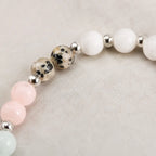 Cancer bracelet close up showing dalmatian jasper beads with polished silver accents in handcrafted zodiac jewelry