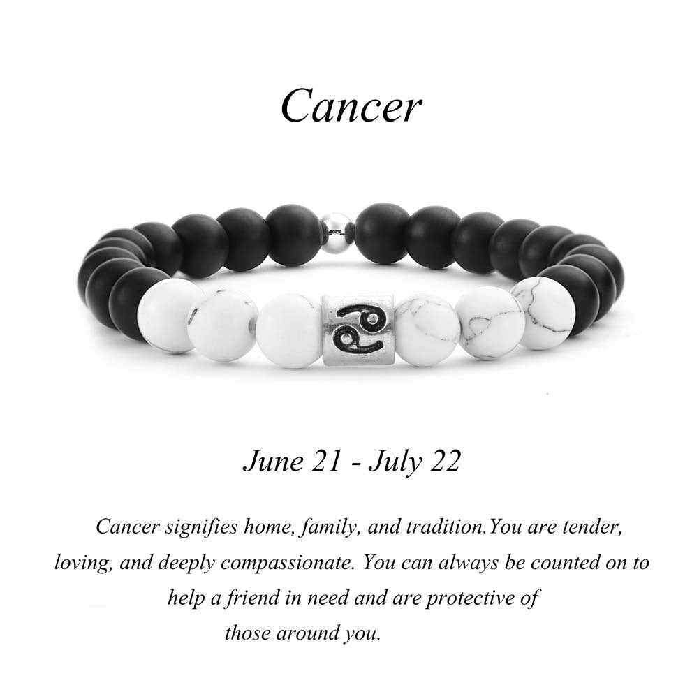 Cancer zodiac bracelet with matte black Agate and white Howlite beads and a silver Cancer crab charm on white background