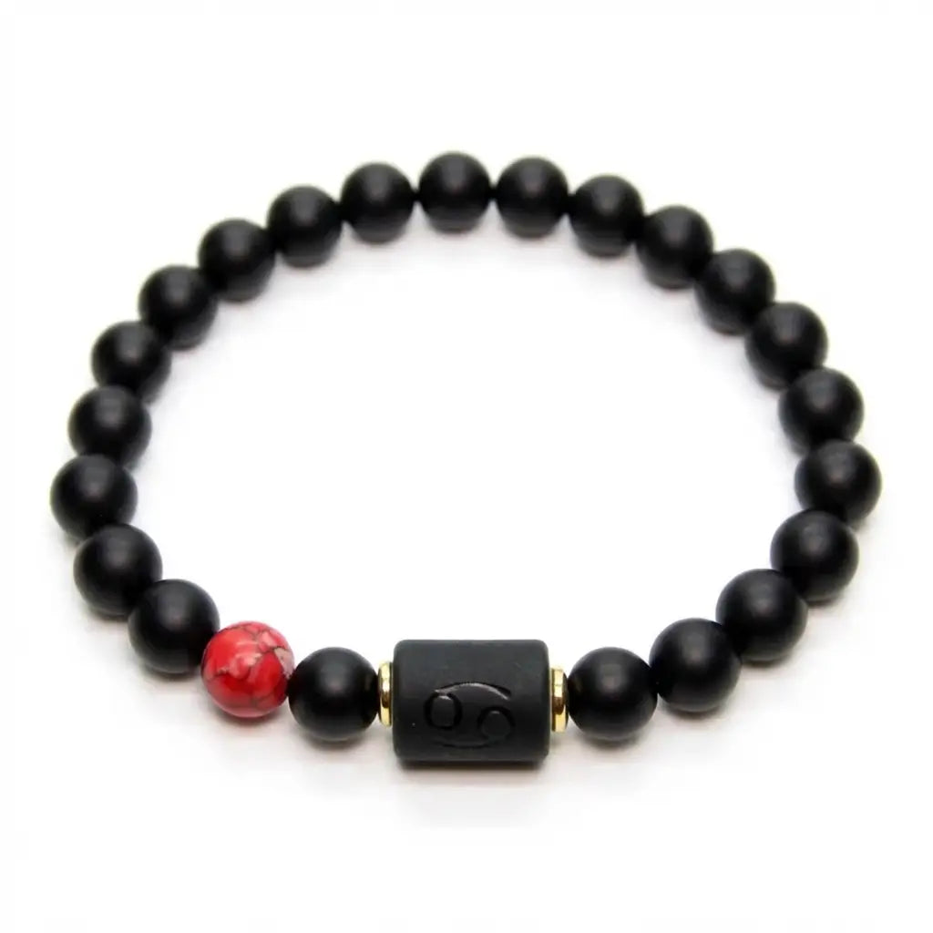 Cancer zodiac bracelet worn by man outdoors with black beads and red stone charm symbolizing strength and personal style energy