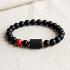 Cancer zodiac bracelet black beaded design with red stone accent and engraved charm for stylish spiritual balance wear