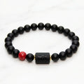 Cancer zodiac bracelet black beaded design on green velvet with red stone accent perfect for luxury gift and elegant presentation