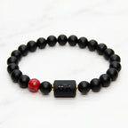 Cancer zodiac bracelet black beaded design on green velvet with red stone accent perfect for luxury gift and elegant presentation
