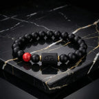 Cancer zodiac bracelet black beads with red accent on marble surface showcasing high end luxury jewelry styling and refined modern appeal
