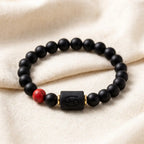 Cancer zodiac bracelet minimalist black bead design with red stone detail and engraved charm for modern spiritual jewelry lovers