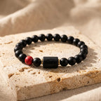 Cancer zodiac bracelet luxury black beads with red accent displayed on reflective surface creating elegant and premium jewelry appeal