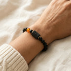 Capricorn zodiac bracelet close-up with lava beads and amber accent, offering grounding style for daily wear comfort