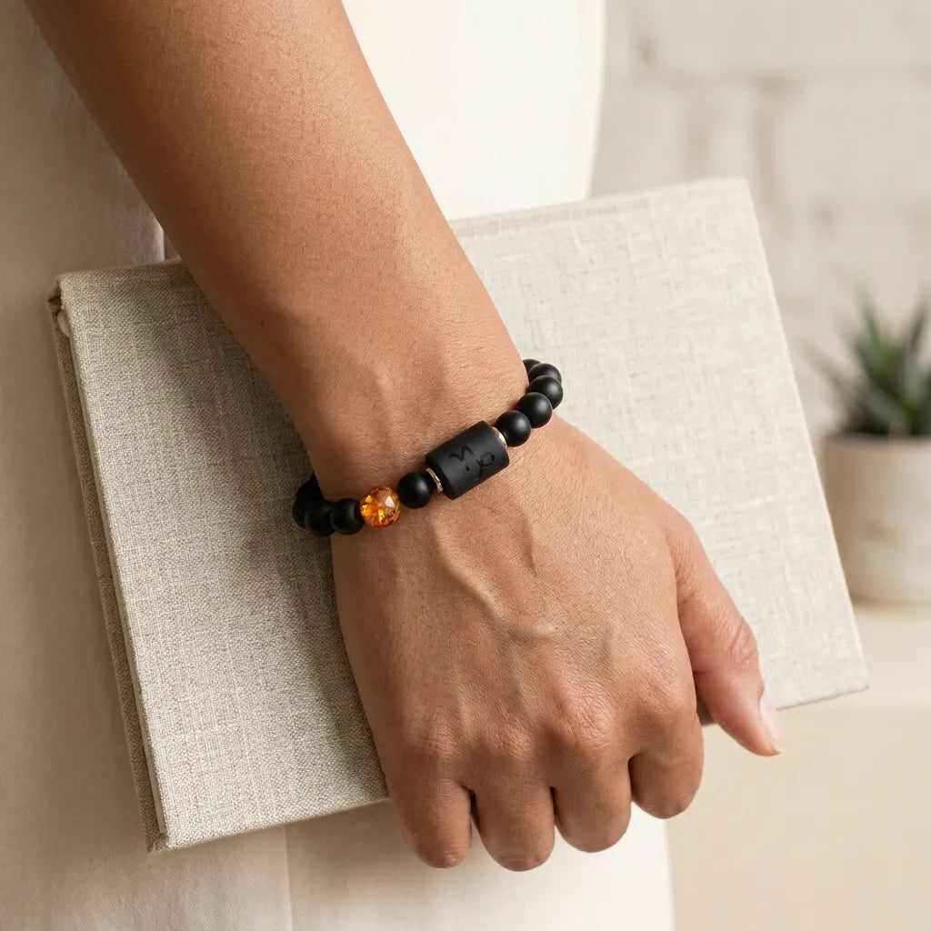 Capricorn zodiac bracelet with matte black beads and amber accent, finished for elegant gift-ready styling today