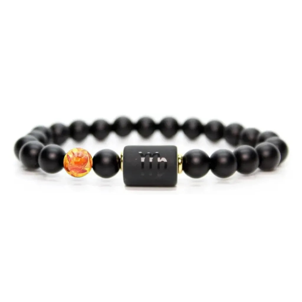 Capricorn zodiac bracelet isolated on white background, black beads and amber accent highlight clean minimalist jewelry design