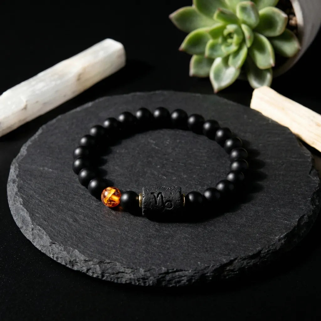 Capricorn zodiac bracelet on black stone with beads and amber charm, showcasing minimalist natural jewelry appeal
