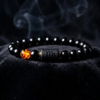 Capricorn zodiac bracelet on black fabric with smoke detail, black beads and amber charm create bold luxury night aesthetic