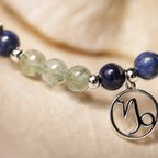 Capricorn zodiac crystal bracelet close up featuring silver Capricorn charm with premium gemstone beads for elegant astrology jewelry.
