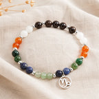 Capricorn zodiac crystal bracelet arranged on linen fabric highlighting natural gemstone colors and artisan craftsmanship.